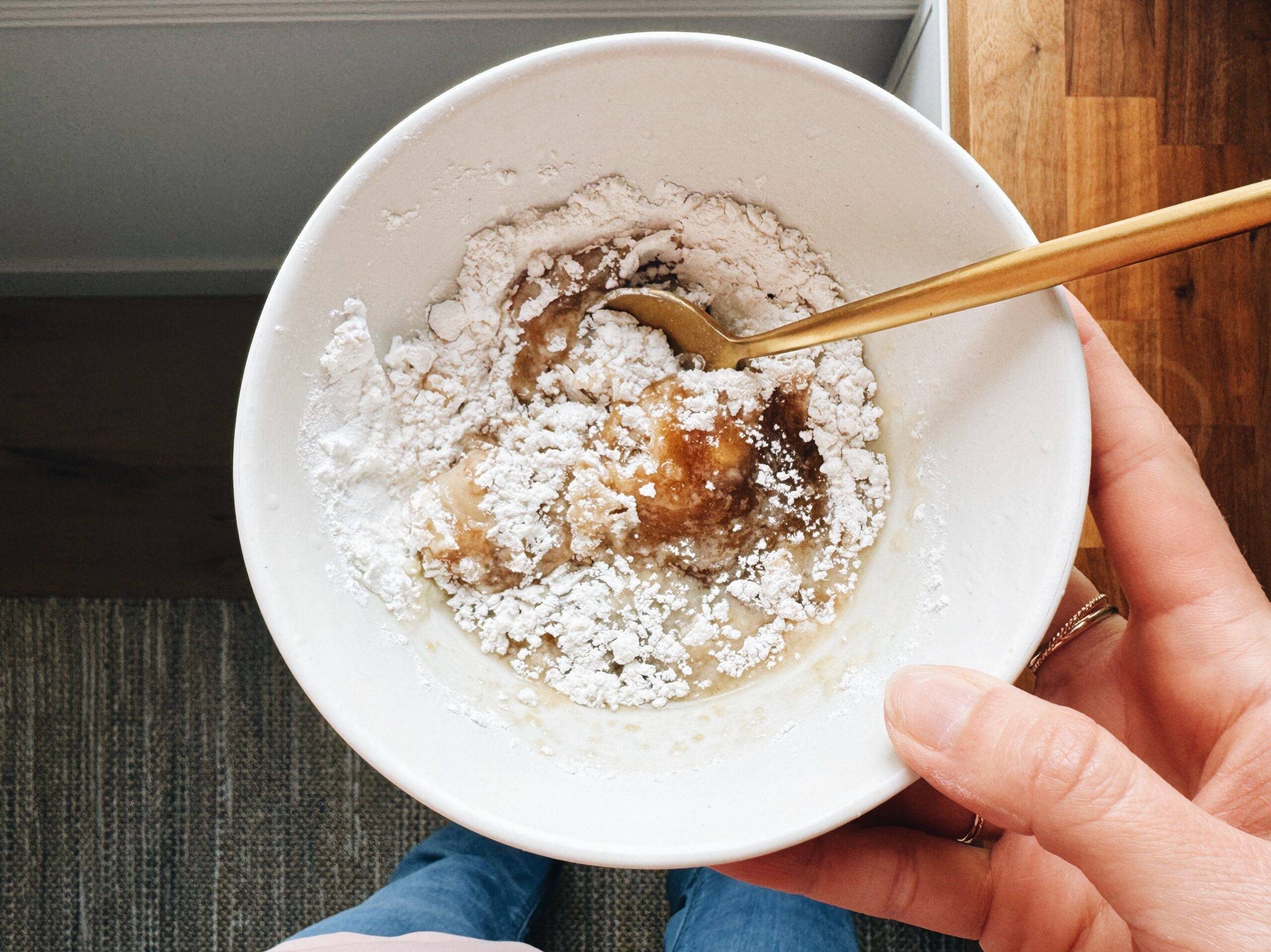 Adding flour to cookie dough.