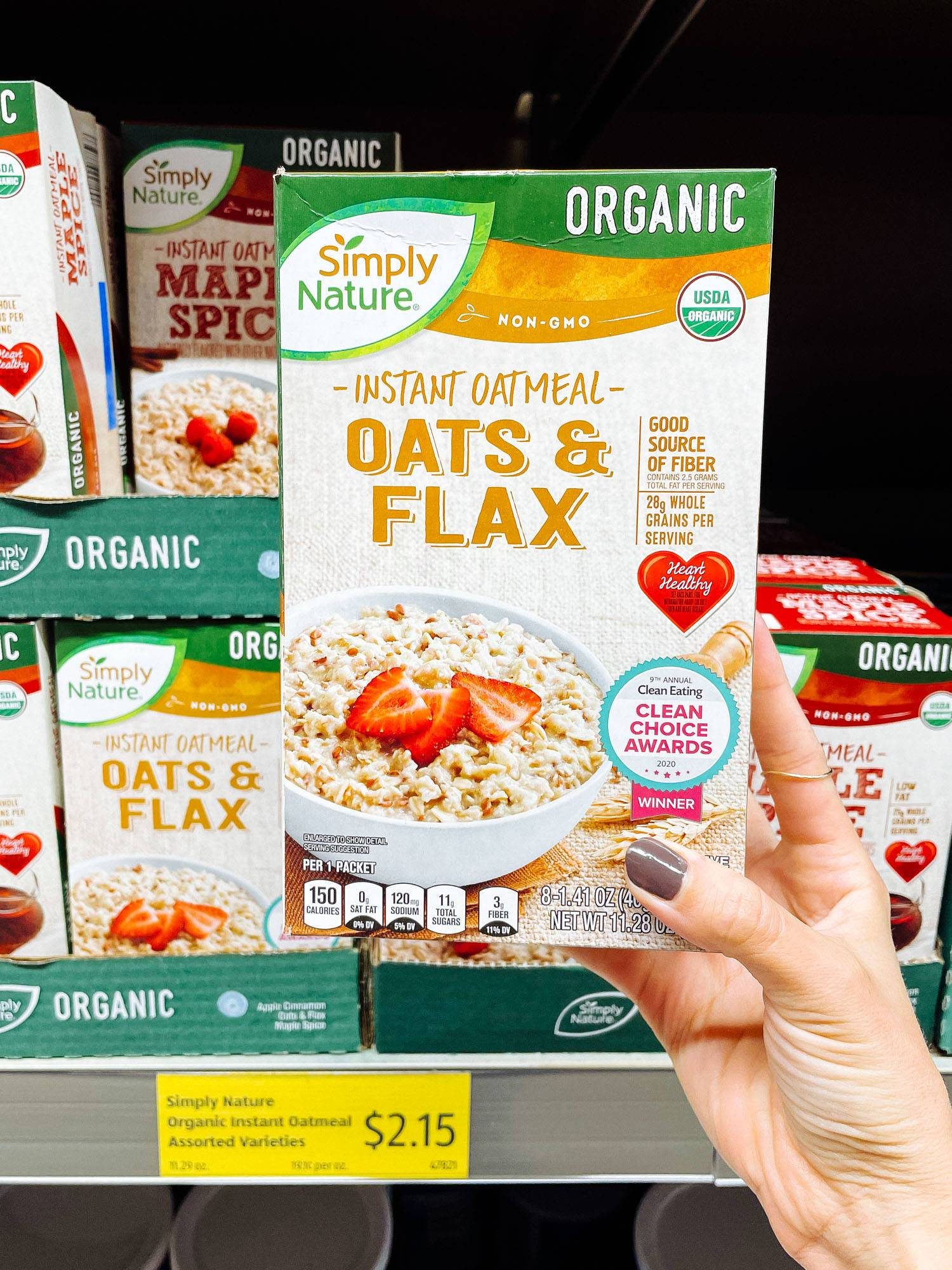 White hand holding instant oatmeal from ALDI.