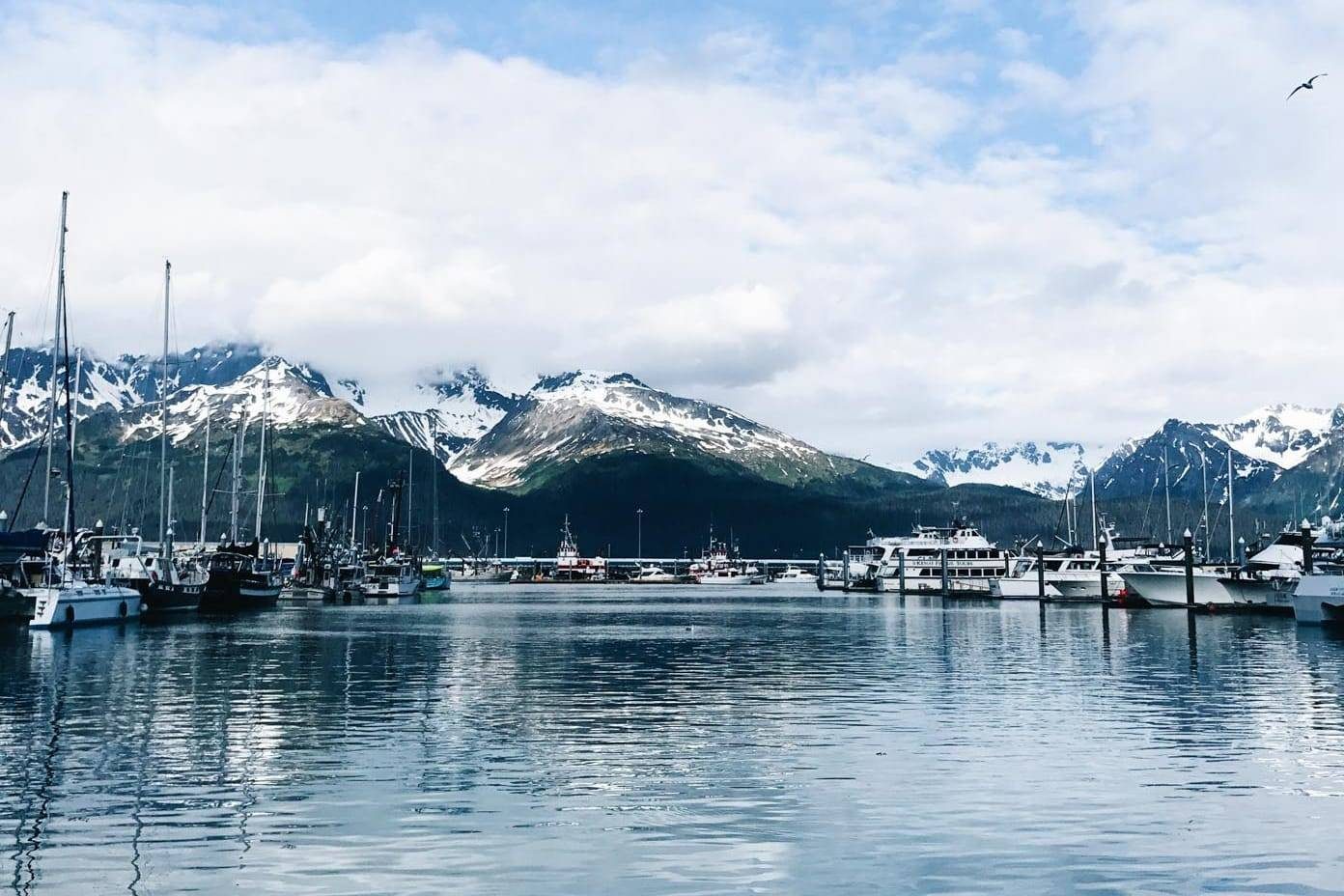 Boats on the water and mountains.