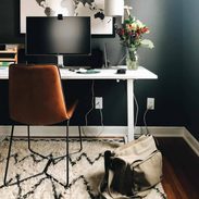 Desk against a dark painted wall.
