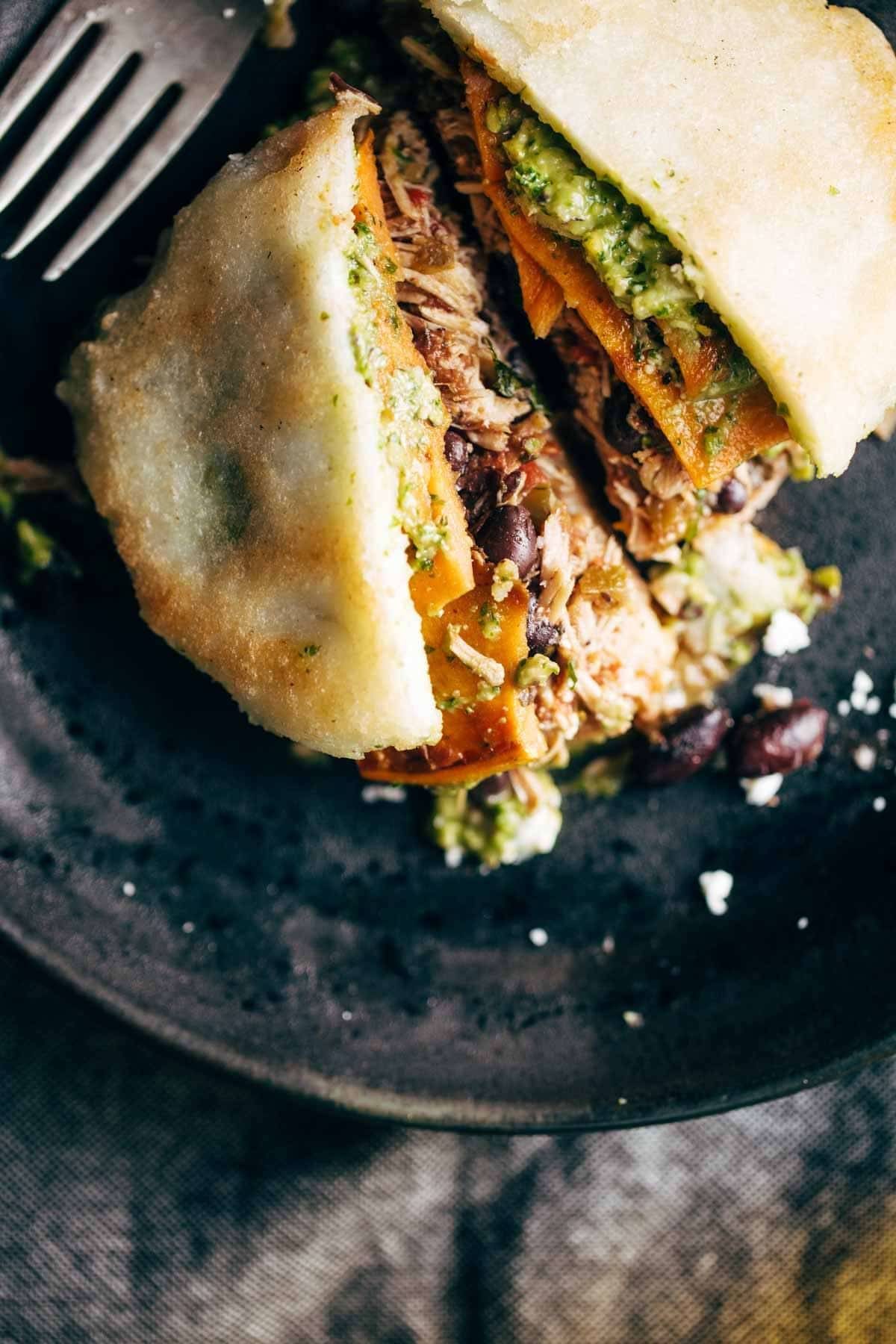 Arepa on a plate with a fork.