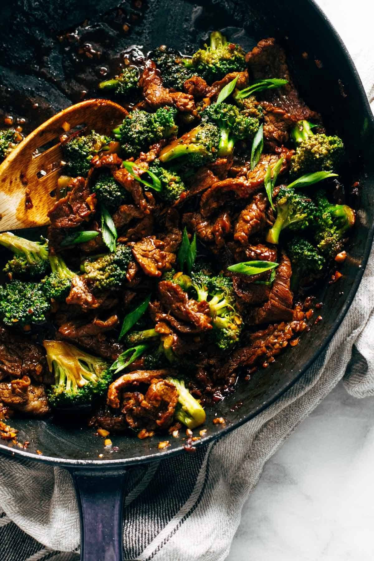 Sesame beef and broccoli in a skillet.