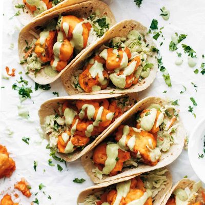 Buffalo cauliflower tacos drizzled with creamy avocado sauce.