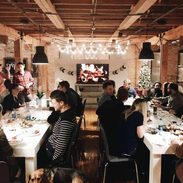 Group of friends at tables for a Christmas party.