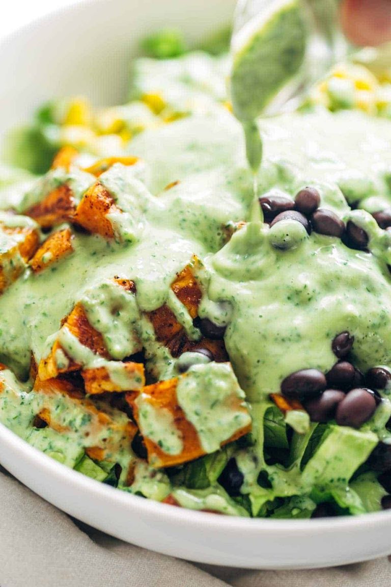 Avocado cilantro dressing poured on a salad.