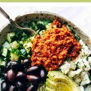 Mediterranean quinoa bowls with red pepper sauce.