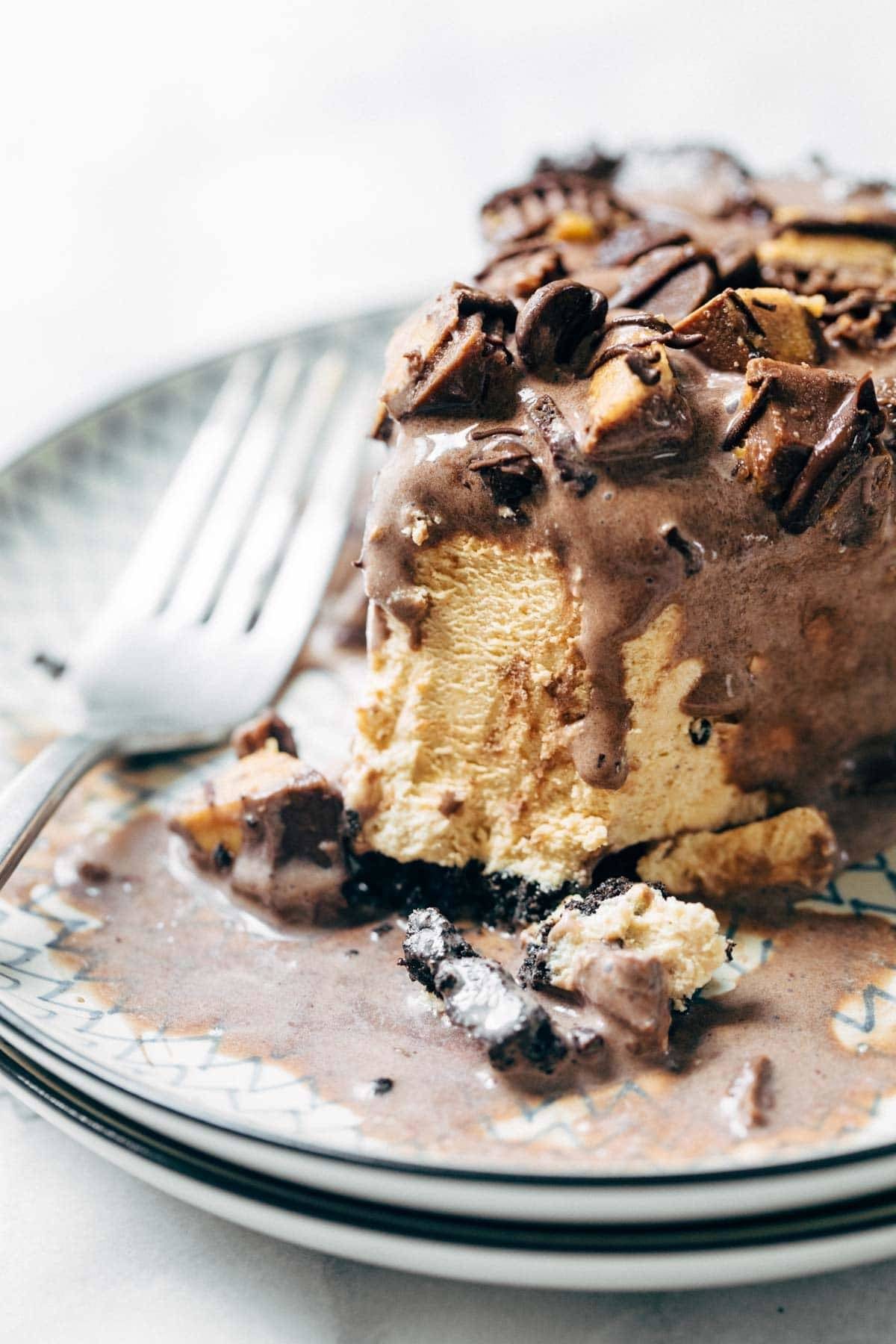 Bite taken out of Mocha Peanut Butter Pie on a plate with a fork.