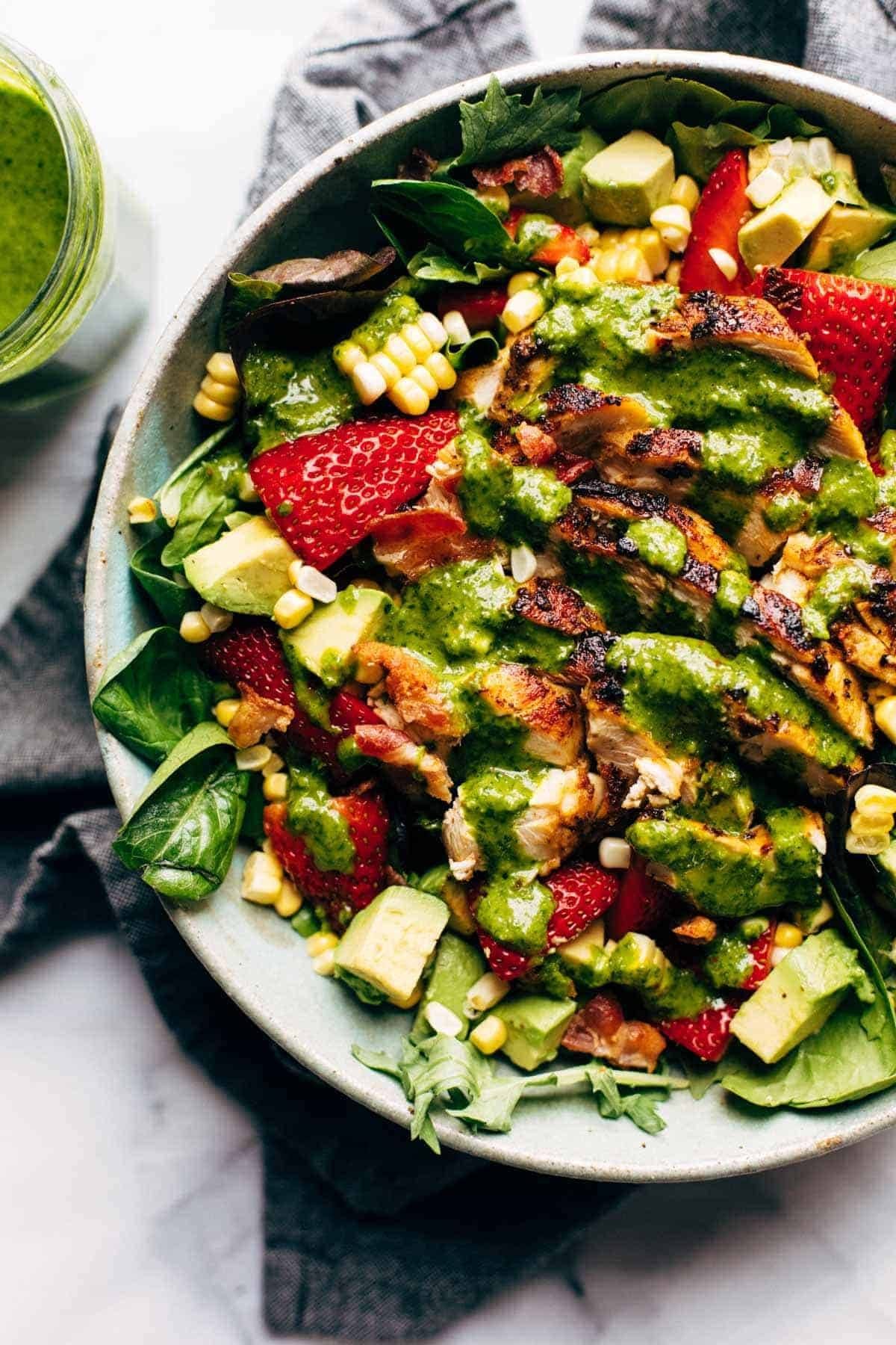 Salad with grilled chicken, berries, corn, and cilantro vinaigrette.